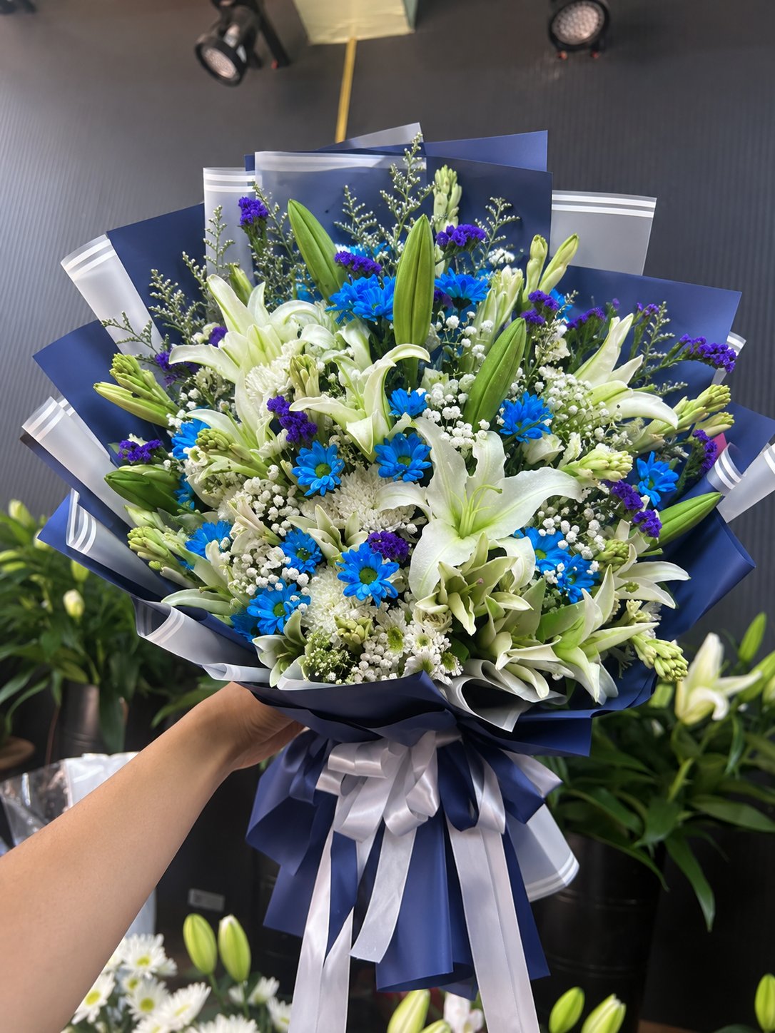 The Midnight Serenade: Royal Blue Daisy & White Lily Symphony